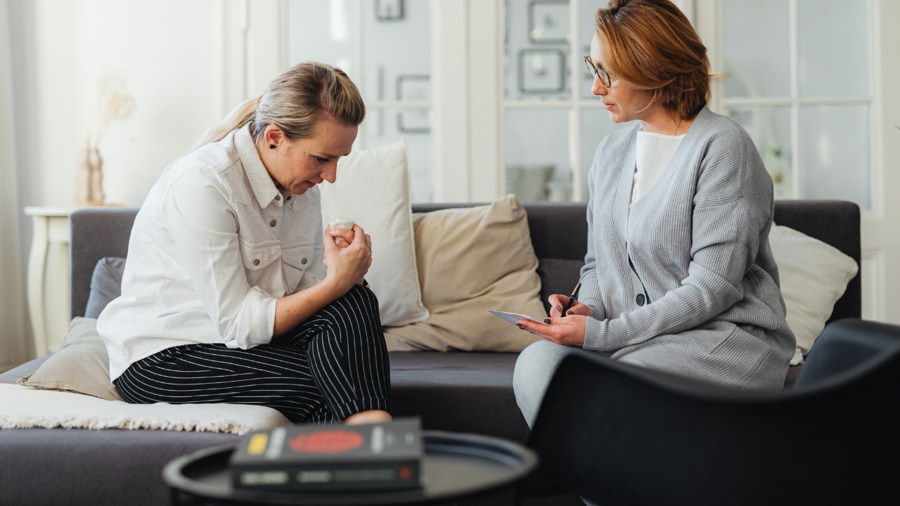A lady with complex PTSD in a therapy session speaking with her therapist