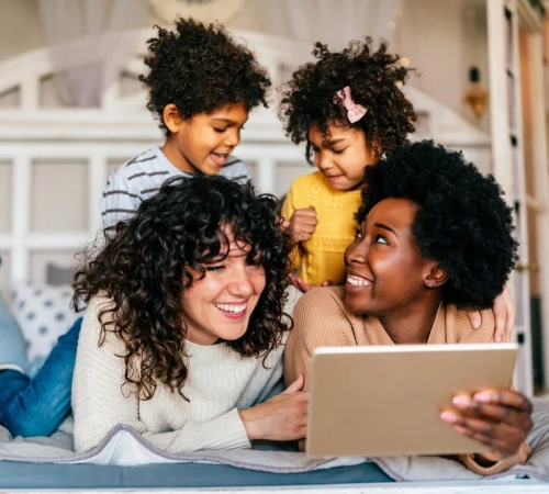 two-lgbtq-ladies -smiling-with-their-kids